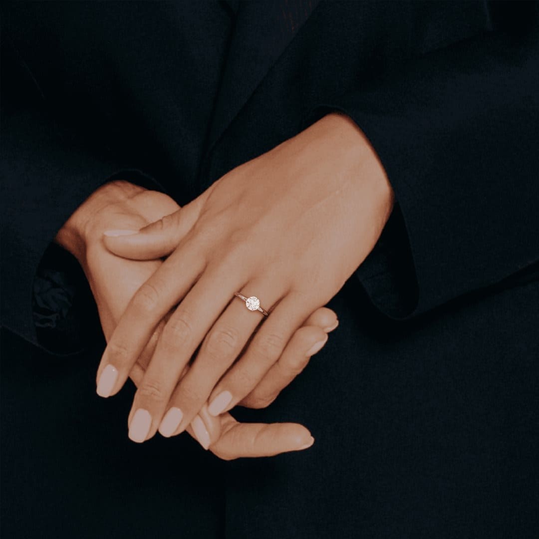 MYZA 1 carats IGI certified lab-grown diamond ring in 18kt hallmark gold, showcasing its elegance on a woman's finger. This ring meets ISO and BIS standards, ensuring quality and authenticity. Certified by IGI, it guarantees excellence. Elevate your style with this exquisite piece, crafted with precision and care.