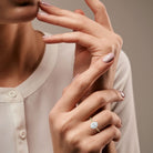 oval cut lab-grown diamond ring in 18K hallmark gold displayed on a woman's hand. This view emphasizes the ring's stunning brilliance, showcasing its elegant oval cut diamond and luxurious setting, making it a perfect choice for a sustainable engagement or wedding ring.