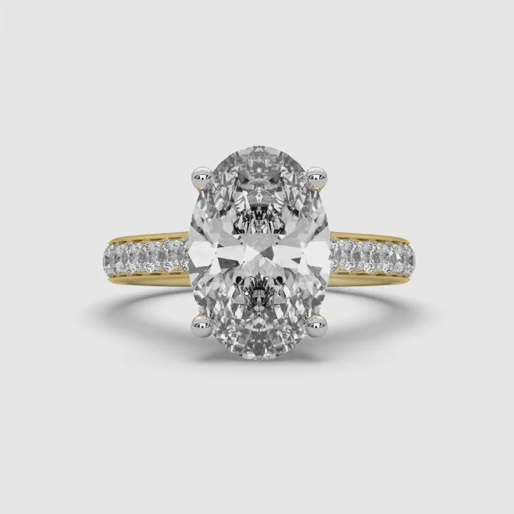 360-degree video of MYZA Diamonds' 4-carat oval cut lab-grown diamond ring in 18K hallmark gold. The rotating view showcases the brilliance, size, and intricate detailing of the oval cut diamond from all angles, emphasizing its luxurious, sustainable design for a stunning engagement or wedding ring.