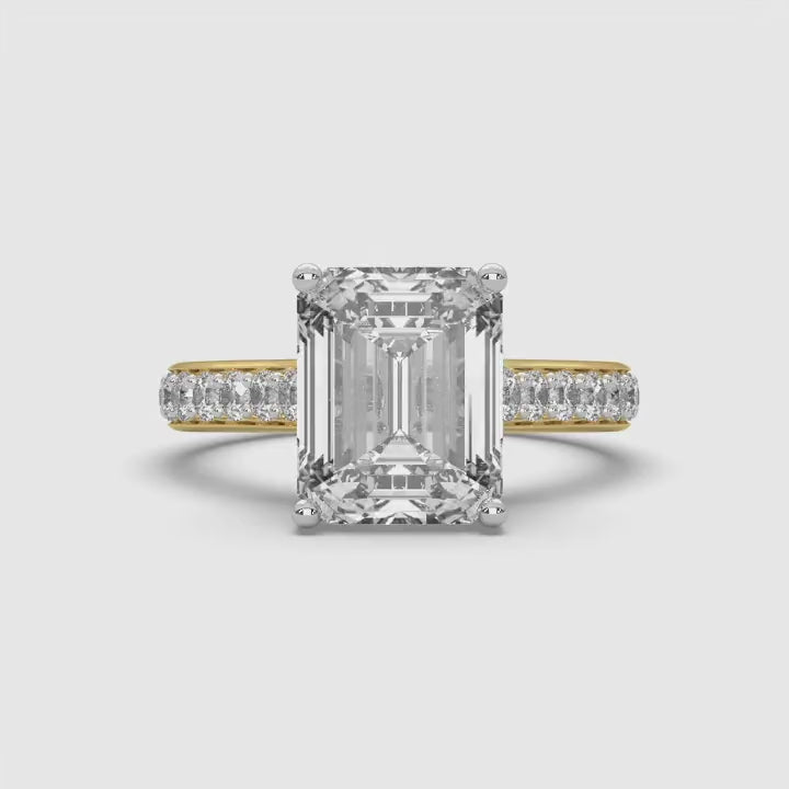 360-degree rotating video of MYZA Diamonds' 4-carat eternity band emerald cut lab-grown diamond ring in 18K hallmark gold. The video showcases the brilliance and continuous row of emerald cut diamonds from all angles, highlighting the sustainable luxury and impeccable craftsmanship of the design, ideal for engagement or wedding rings.