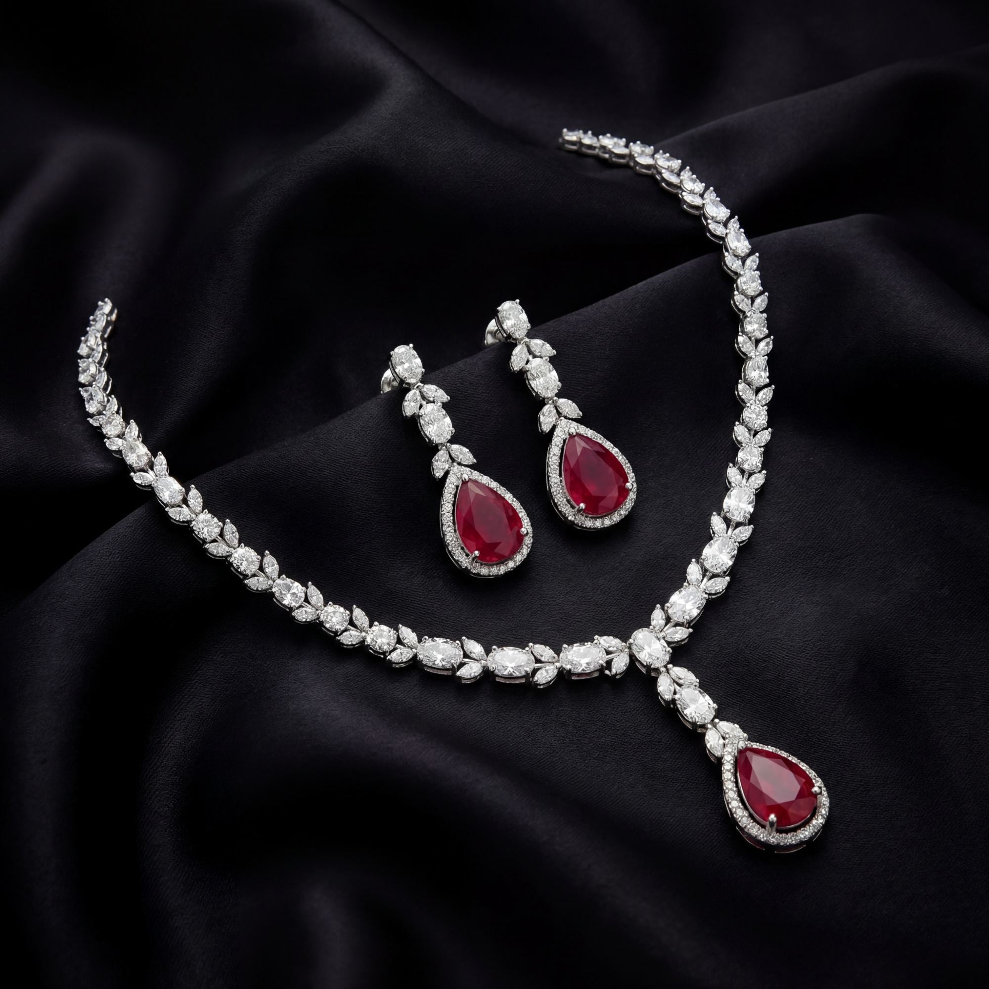 This 22 Carat MYZA set is a masterpiece of passionate color and refined geometry. By combining the deep, fiery allure of pear-cut rubies with a sophisticated mix of diamond shapes, this set creates a look of timeless majesty.