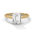 Front view of MYZA Diamonds' 4 carat emerald cut lab-grown diamond classic band ring in 18K hallmark gold. This strikingly elegant design showcases a large, brilliant lab-grown diamond, offering a sustainable and luxurious option for engagement or wedding rings.