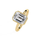Shop MYZA's 2 carat IGI certified emerald cut lab-grown diamond bezel set engagement ring in 18K hallmarked gold. Ethical luxury, certified brilliance.