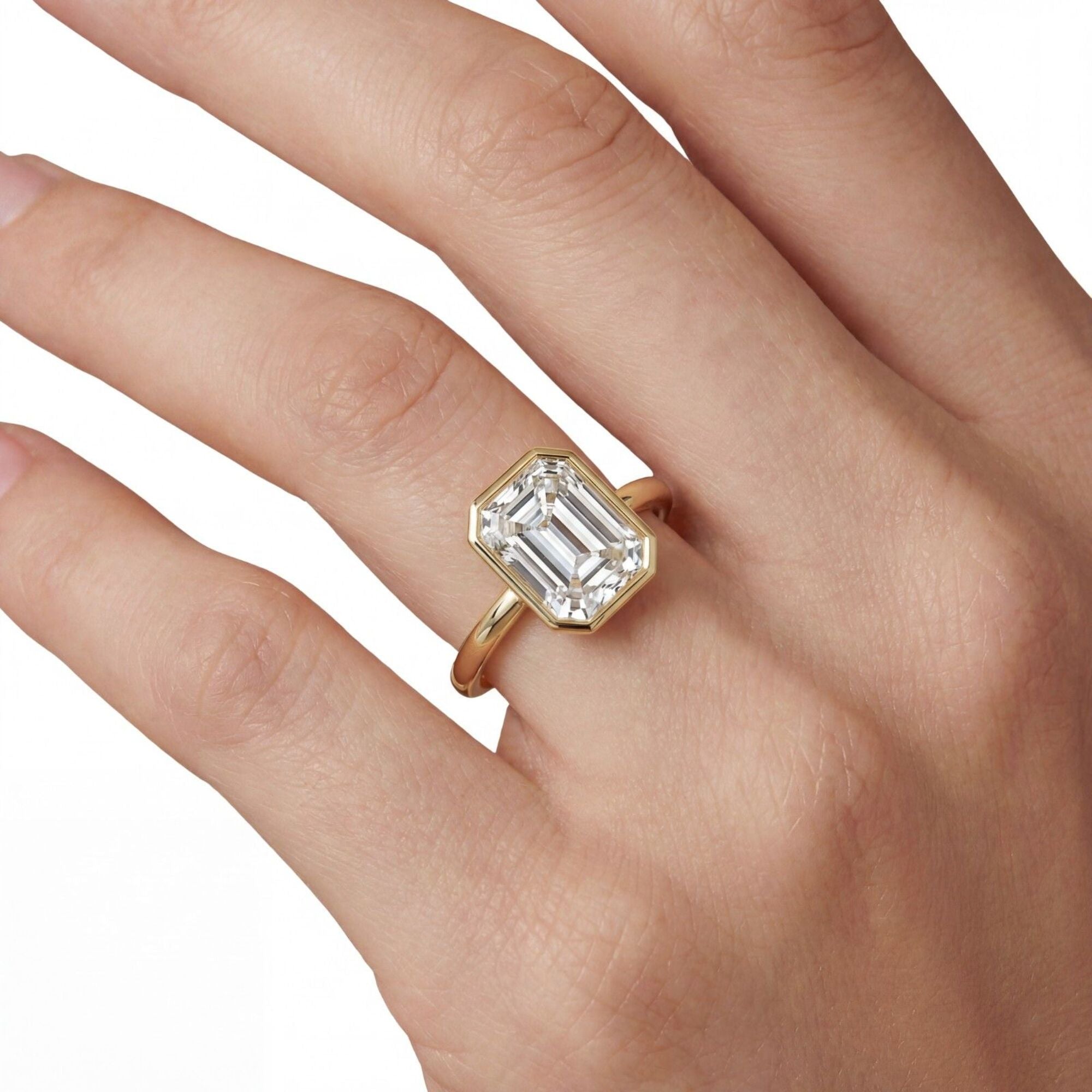 Shop MYZA's 2 carat IGI certified emerald cut lab-grown diamond bezel set engagement ring in 18K hallmarked gold. Ethical luxury, certified brilliance.