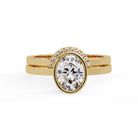 Shop MYZA's 2 Carat IGI Certified Oval Cut Lab-Grown Diamond Bridal Set Ring in 18K Hallmarked Gold with 10 round side diamonds. Ethical luxury, certified brilliance.