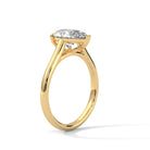 all-groups MYZA pear-shaped lab-grown diamond ring with a yellow gold band, displayed in a standing side-angle view. This image offers a slightly angled perspective of the ring, highlighting the profile of the band and the elegant design of the diamond.