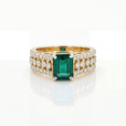 This MYZA Certified 1.5 Carats Emerald Cut Zambian Green Women's Ring  features a vivid lab-grown Zambian emerald in a 14K hallmarked gold setting, offering a sleek, sophisticated balance of classic step-cut elegance and brilliant diamond accents.