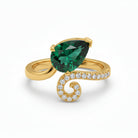 This MYZA Certified 1.7 Carats Pear Cut Zambian Women's ring showcases a vibrant, lab-grown Zambian emerald in a 14K hallmarked gold setting, combining a contemporary teardrop silhouette with a brilliant diamond halo for a sustainable luxury finish.