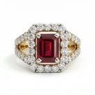 This MYZA Certified 1.8 Carats Emerald Cut Ruby Red Gemstone Women's Ring features a vivid, lab-grown ruby set in 14K hallmarked gold, combining the stone’s passionate crimson fire with a sophisticated "hall of mirrors" design and brilliant ethical diamond accents.