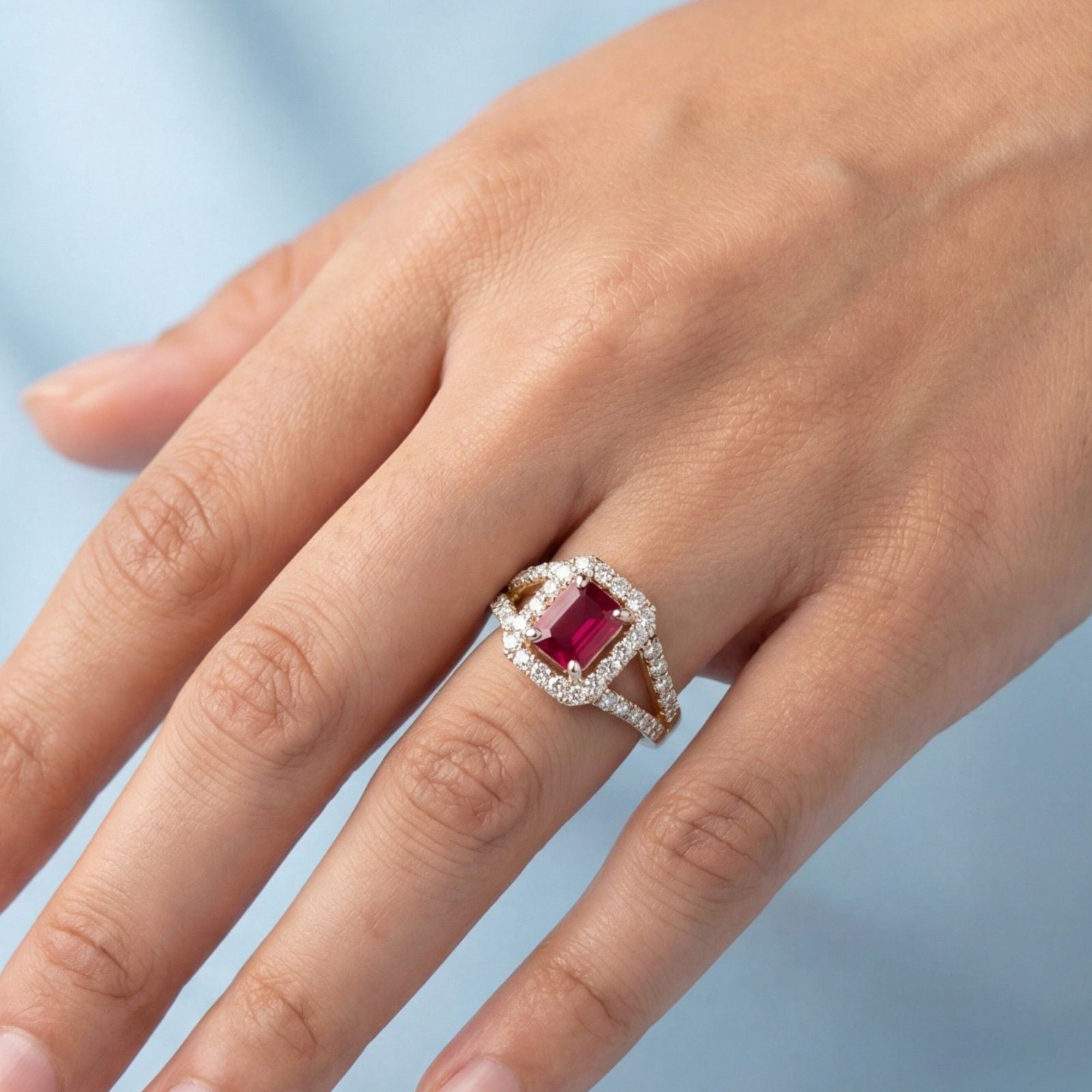 This MYZA Certified 1.8 Carats Emerald Cut Ruby Red Gemstone Women's Ring features a vivid, lab-grown ruby set in 14K hallmarked gold, combining the stone’s passionate crimson fire with a sophisticated "hall of mirrors" design and brilliant ethical diamond accents.