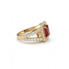 This MYZA Certified 1.8 Carats Emerald Cut Ruby Red Gemstone Women's Ring features a vivid, lab-grown ruby set in 14K hallmarked gold, combining the stone’s passionate crimson fire with a sophisticated "hall of mirrors" design and brilliant ethical diamond accents.