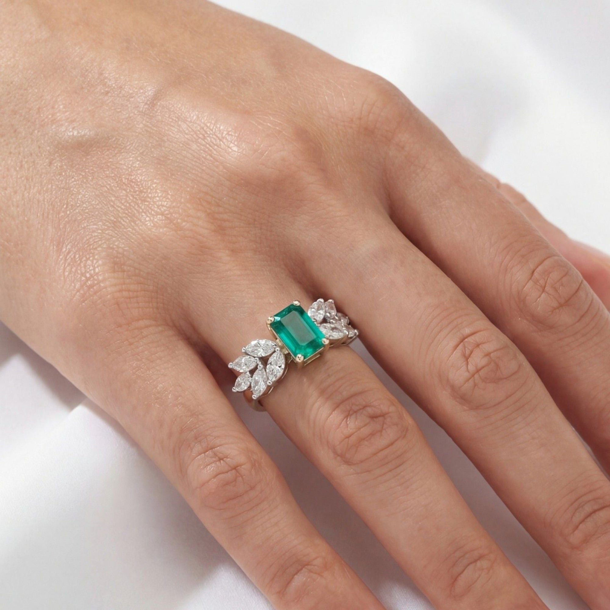 This MYZA Certified 1 Carats Emerald Cut Zambian Green Women's ring features a vivid, lab-grown Zambian emerald set in 14K hallmarked gold, offering a sleek, "hall of mirrors" aesthetic paired with brilliant, sustainable diamond accents.