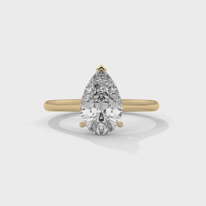 all-groups 360-degree view of the MYZA pear-shaped lab-grown diamond ring with a yellow gold band. This rotating view showcases the ring’s elegant design from all angles, highlighting its high-quality craftsmanship and the luxurious appeal of the diamond.